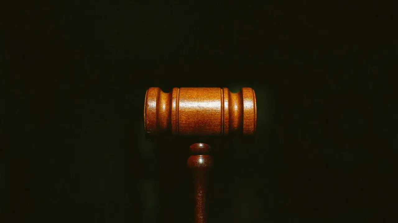 Martelletto da giudice in legno scuro, simbolo di giustizia e del convenuto significato.