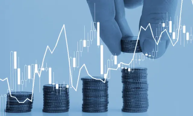 Mani aggiungono monete a pile crescenti, con un grafico finanziario che mostra una tendenza al rialzo. Un'immagine che simboleggia la crescita e l'uscita da un "pool" di investimenti.